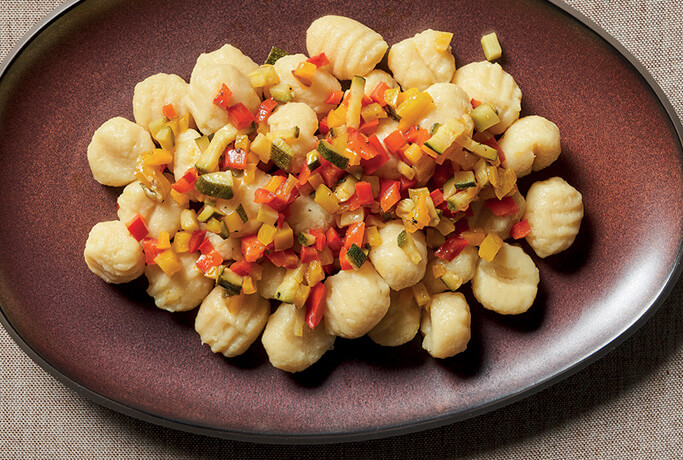 Organic eggless striped potato gnocchi with sweet and sour diced vegetables