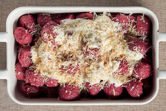 Potato gnocchi with beetroot with Gorgonzola cream and smoked ricotta cheese