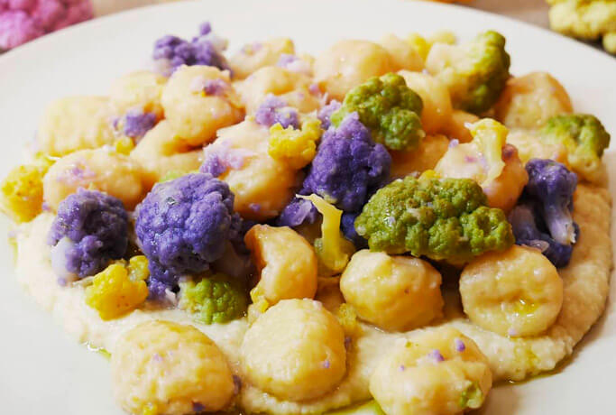 Organic gnocchi with spelt flour, cannellini bean cream and colorful cauliflowers