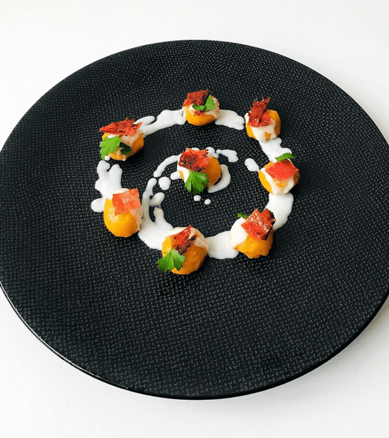 Potato gnocchi with pumpkin, stracchino cheese fondue and Spanish salami chips